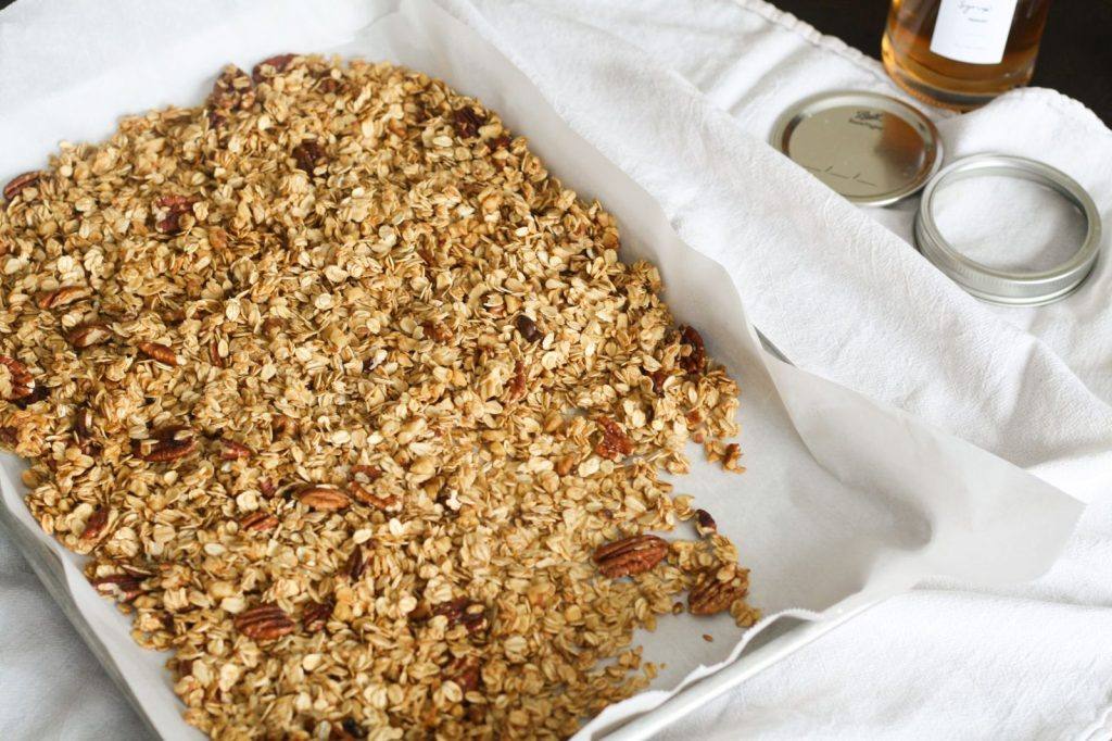 Baked granola on a tray lined with baking paper