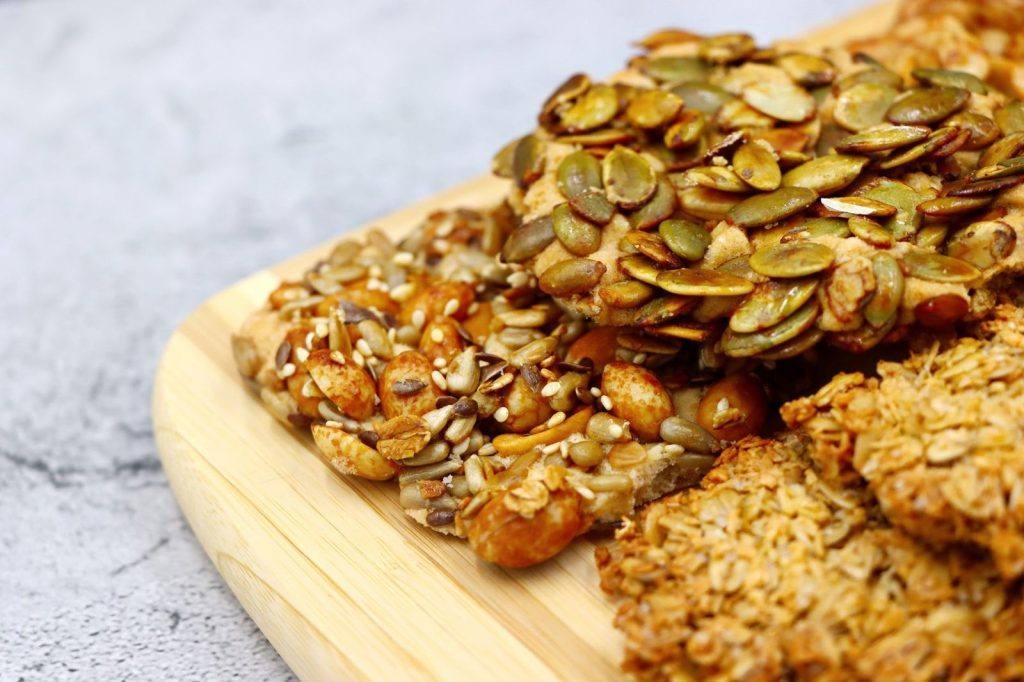 Seed-crusted energy bars on a wooden board