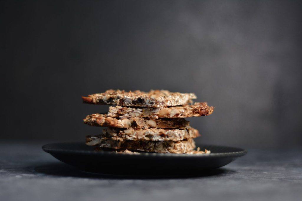 Stack of seed and fruit bars on a dark plate