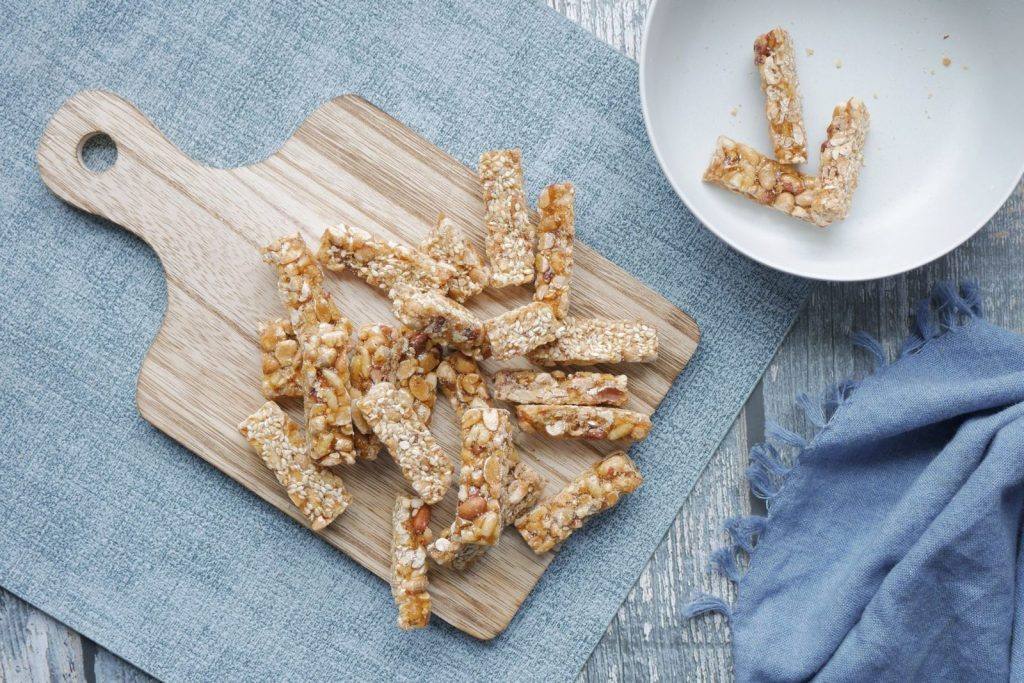Homemade oat and nut bars on a wooden cutting board