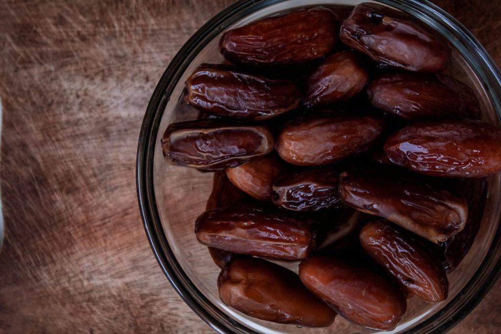 Bowl of dates on a wooden table