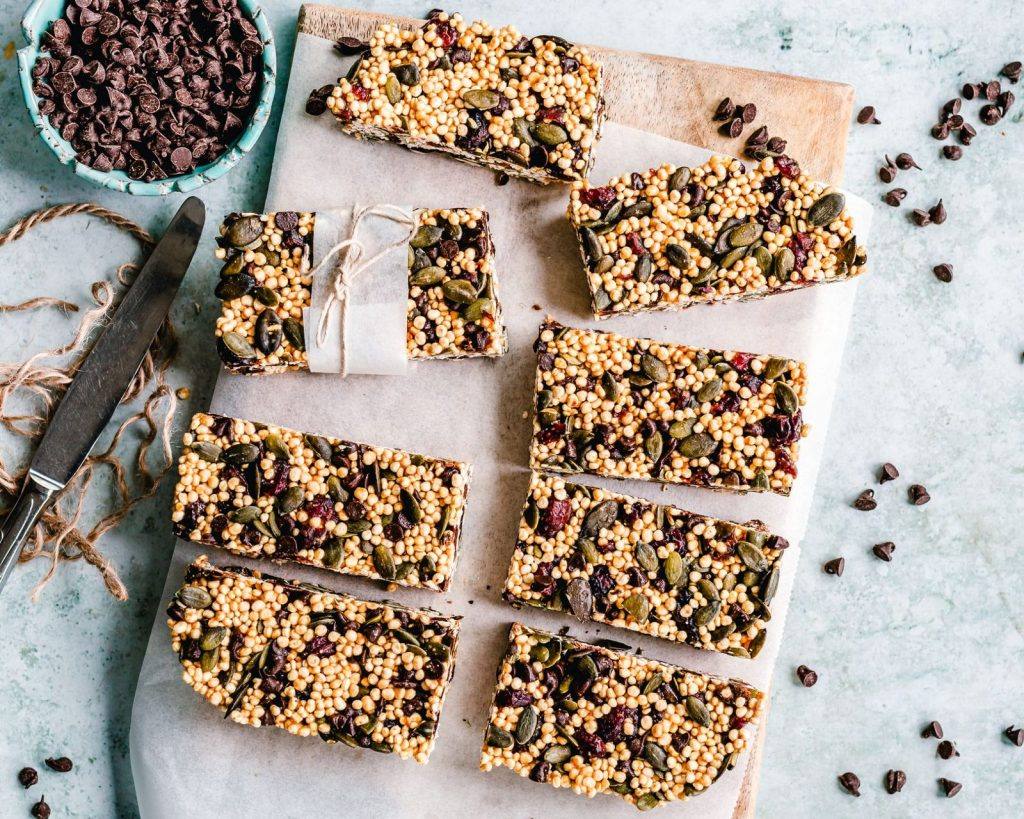 Rows of chocolate chip grain bars on baking paper
